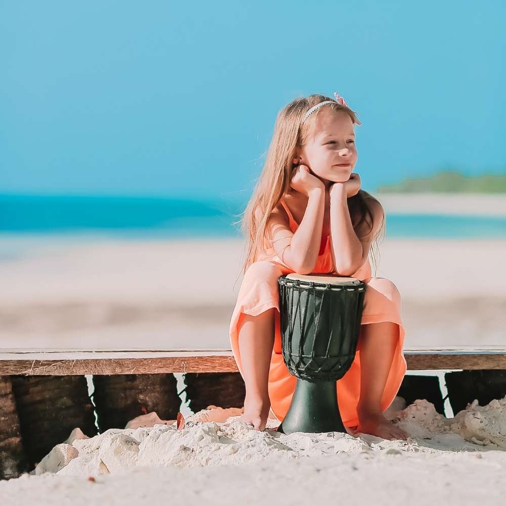 Child relaxing after playing the drums